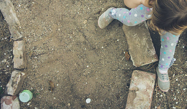 istock Baby girl playing in sand 516985856