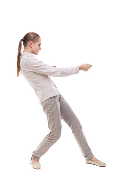 istock back view of standing girl pulling  rope from top 516986314