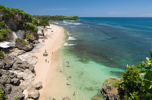 Bali, Indonesia - March 20, 2016: Aerial view of the beach of Balangan on the southern tip of magical Bali in Indonesia. The waters are crystal clear and people can easily snorkel and also practice surf along the coral reef.
