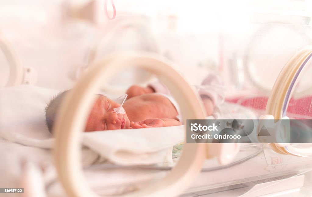 Premature newborn  baby girl Premature newborn  baby girl in the hospital incubator after c-section in 33 week Premature Stock Photo