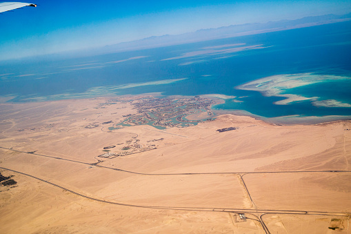 View on the sea and the desert from an airplane