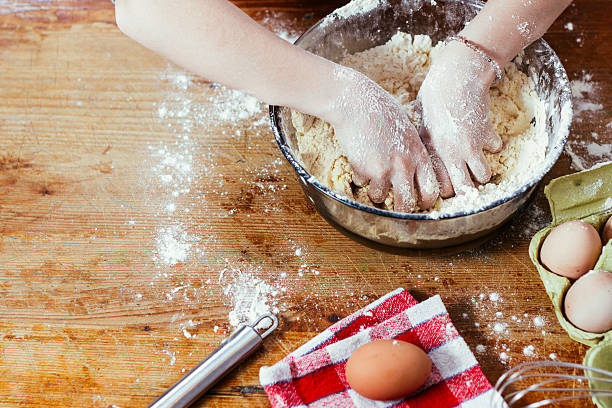 istock Girl in the kitchen playing with flour 517004254