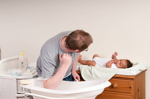 istock Father Keeping An Eye On His Baby Whilst Checking Temperature 517004692