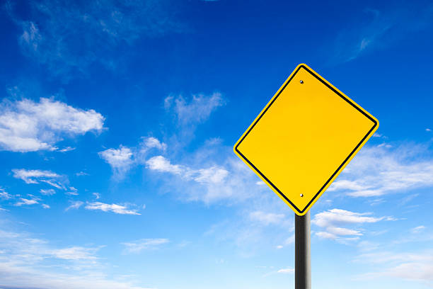 Empty Road Sign Against Blue Sky With Copy Space An empty road sign with copy space against blue sky. Conceptual image. road warning sign photos stock pictures, royalty-free photos & images