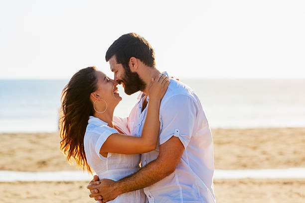 istock Happy couple embracing on sea beach 517011216