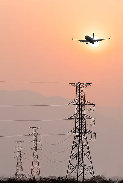 istock Silhouettes  of airplane  landing 517012982