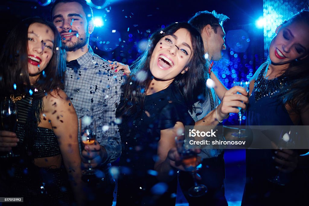 Dancing at party Ecstatic friends dancing at night party Nightclub Stock Photo