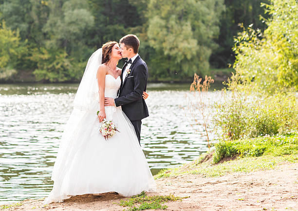 istock Wedding couple standing and hugging near lake 517014864