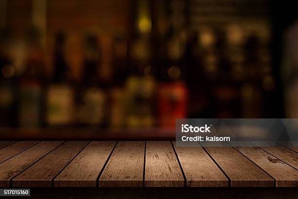 Wooden Table With A View Of Blurred Beverages Bar Backdrop Stock Photo - Download Image Now