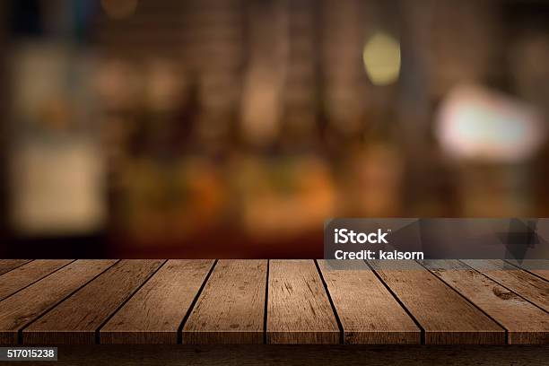 Wooden Table With A View Of Blurred Beverages Bar Backdrop Stock Photo - Download Image Now