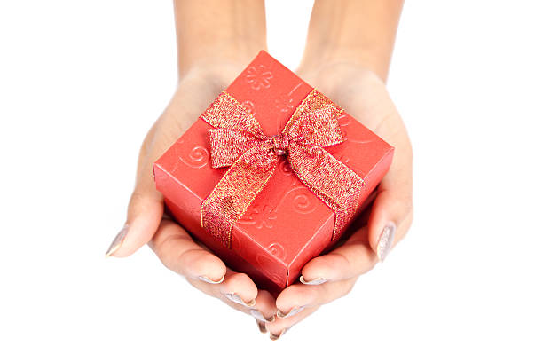 istock Close up of hands  hold red gift box 517015557