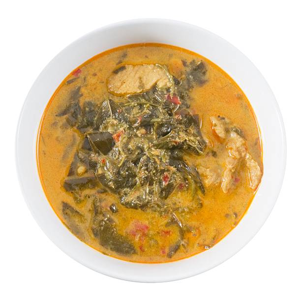 istock Top View Coconut Milk Curry with Cassia Leaves on White 517015920