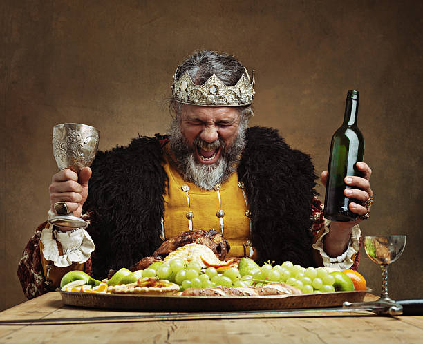 I'm the life of the party! A mature king feasting alone in a banquet hall king royal person stock pictures, royalty-free photos & images