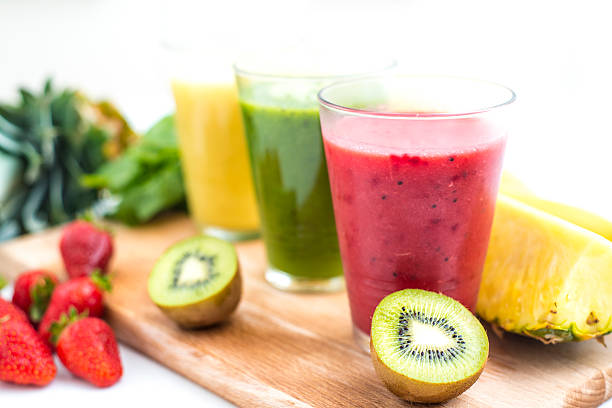 Fresh, healthy smoothies Three fresh, colorful smoothies with some fruit on kitchen table. strawberry crush stock pictures, royalty-free photos & images
