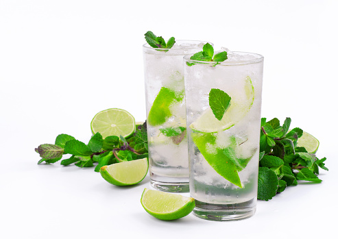 Two mojito cocktail with lime and mint in tumbler glass on white background