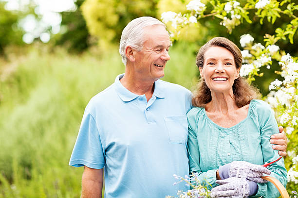 istock Senior Couple Standing In Garden 517017725