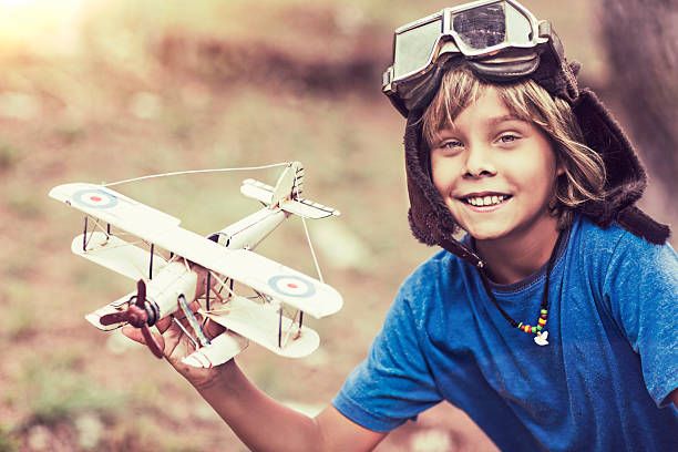 Fun with the plane Kid playing with his old plane toy. stars in your eyes stock pictures, royalty-free photos & images