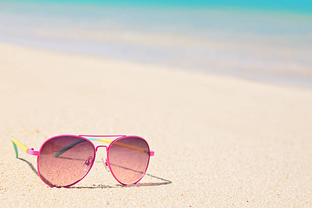 istock Pink Sunglasses on the beach 517018180