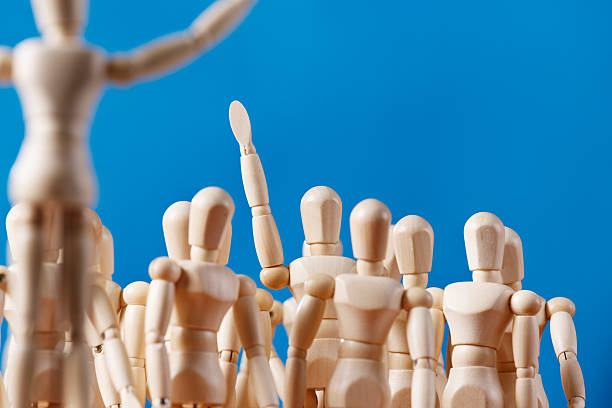 istock Puppet volunteer in crowd raises its hand 517019279