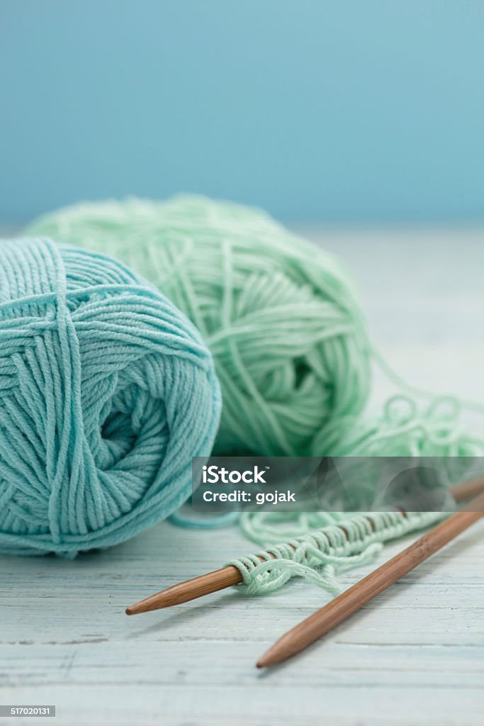 Yarn Knitting needles with light blue and green yarn Ball Of Wool Stock Photo