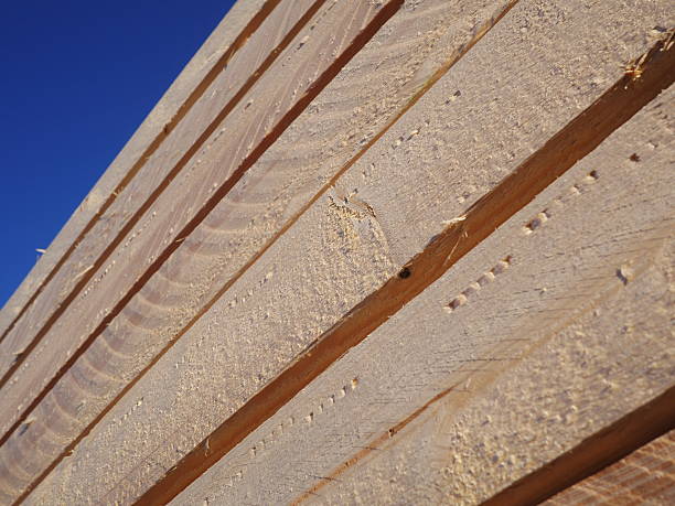 istock Stacks of planks against the deep blue sky 517020335