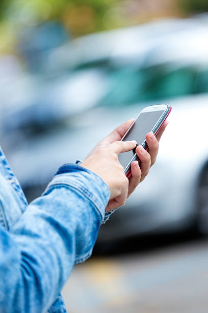 istock Mobile phone in a woman's hand. Outdoor image. 517042331