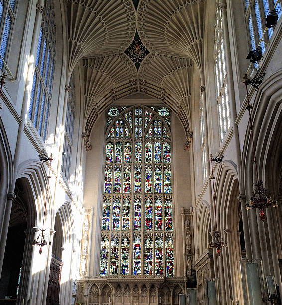 Stained glass window in Bath Abbey Bath, England - October 6, 2014: View of a stained glass window in Bath Abbey, with sunlight on the knave and chancel bath abbey stock pictures, royalty-free photos & images