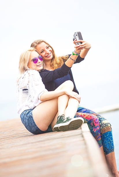 istock Best friends sitting by the sea and having fun 517042901