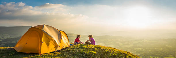 istock Children camping on idyllic summer sunset mountain light panorama 517043607