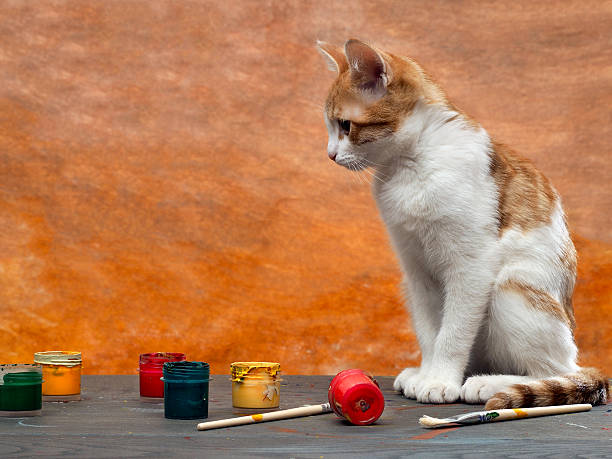 istock On a wooden table paints, brushes and a cute kitten 517044540