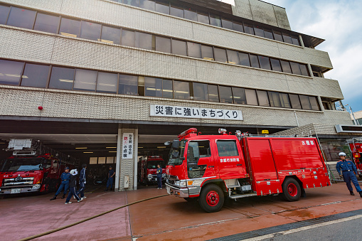 Kyoto, Japan - May 20, 2015: Fire engine and men outside the Kyoto Fire Station in Kyoto, Japan