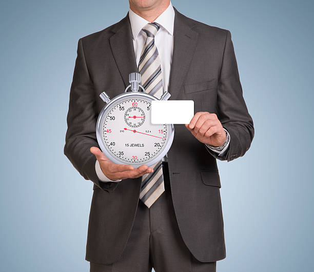 istock Businessman in suit hold empty card and stopwatch 517045433