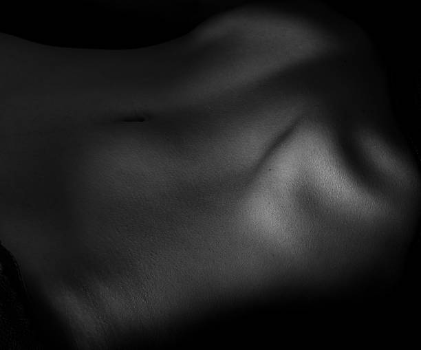 istock Naked belly on dark. 517046174
