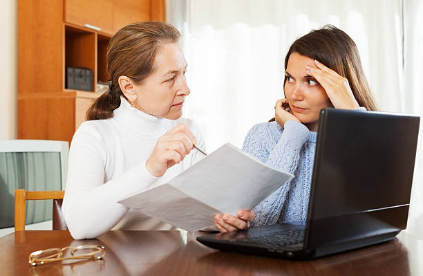 istock mature woman and yong daughter with computer 517046277