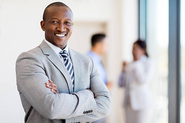 istock african business man with arms folded 517046554