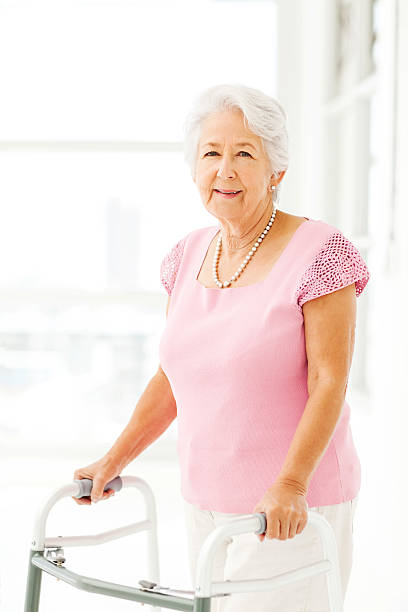 istock Beautiful Senior Woman Using Walker In Nursing Home 517046609