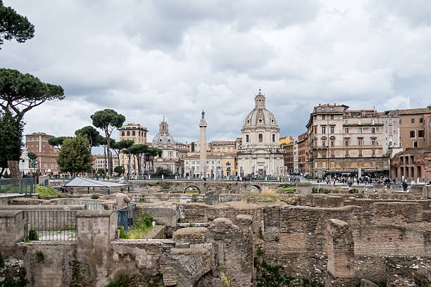 Rome, Italy - 4 April 2015:  View of tourists visiting the Roman ruins near the Roman Forum on a cloudy day  Scenes from Rome, Italy, at Easter time.