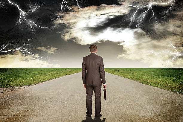 istock Businessman with briefcase standing on the road. Rear view 517047915
