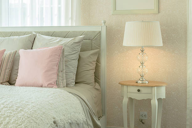 istock cozy bedroom with pink pillows and reading lamp 517048446
