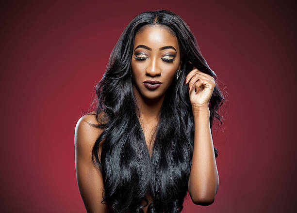 istock Black woman with long luxurious shiny hair 517048449
