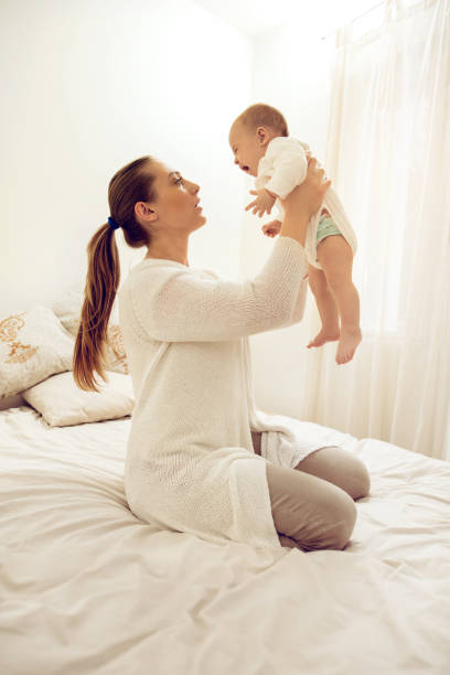 istock Young mother holding her baby who is crying. 517051068