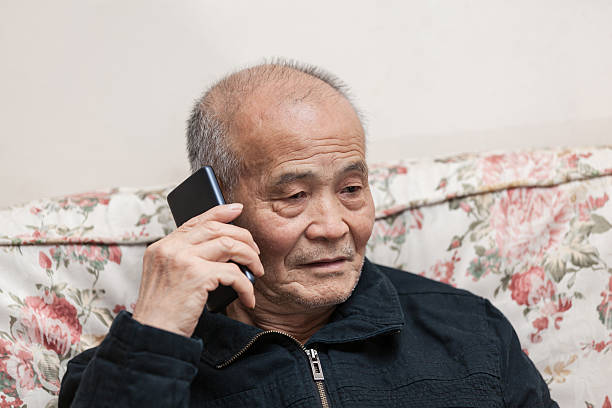 istock Asian old man call indoors 517051412