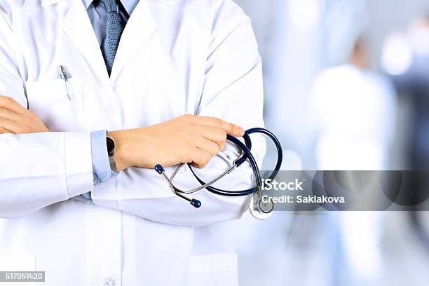 Portrait An Unknown Male Doctor Holding A Stethoscope Behind Stock Photo - Download Image Now