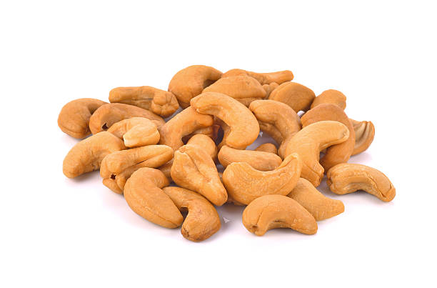 istock Roasted Salted Cashews on white background. 517051958