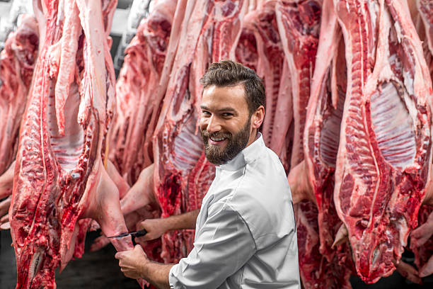 istock Butcher cutting pork at the manufacturing 517055796