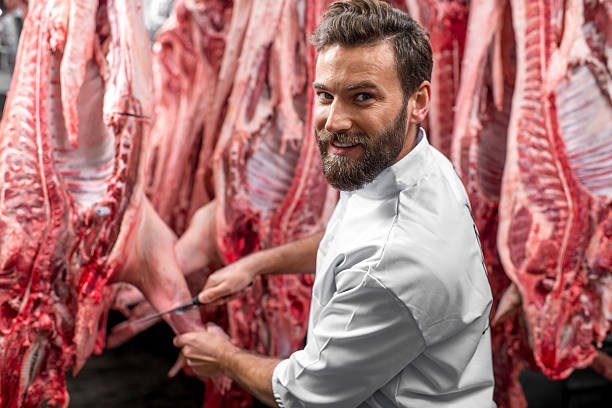 istock Butcher cutting pork at the manufacturing 517055884