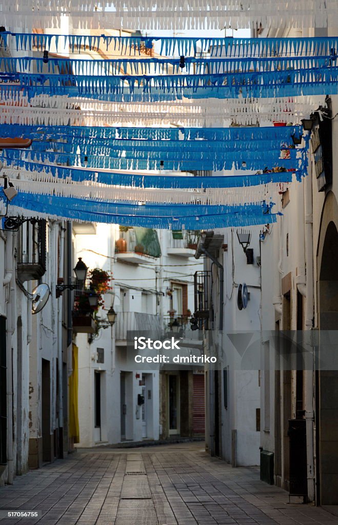 Blue and white shredded paper decorations Blue and white shredded paper decorations over a street in Tossa de Mar Architecture Stock Photo