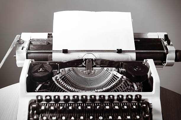 istock Old typewriter on wooden table. Vintage style tinted photo 517056798