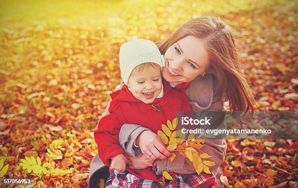Happy Family Mother And Child Little Daughter Play On Autumn Stock Photo - Download Image Now