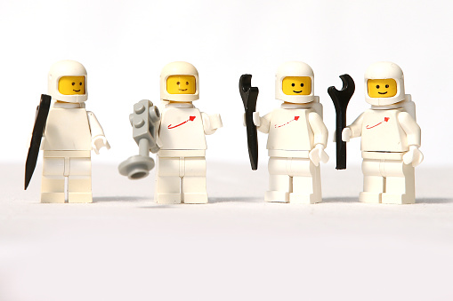 Sydney, Australia - March 23, 2016: Four white Lego astronaut mini figures on a plain white backdrop. Lego is a popular line of plastic construction toys manufactured by The Lego Group, based in Denmark and these toys are from the late 1970's to early1980's